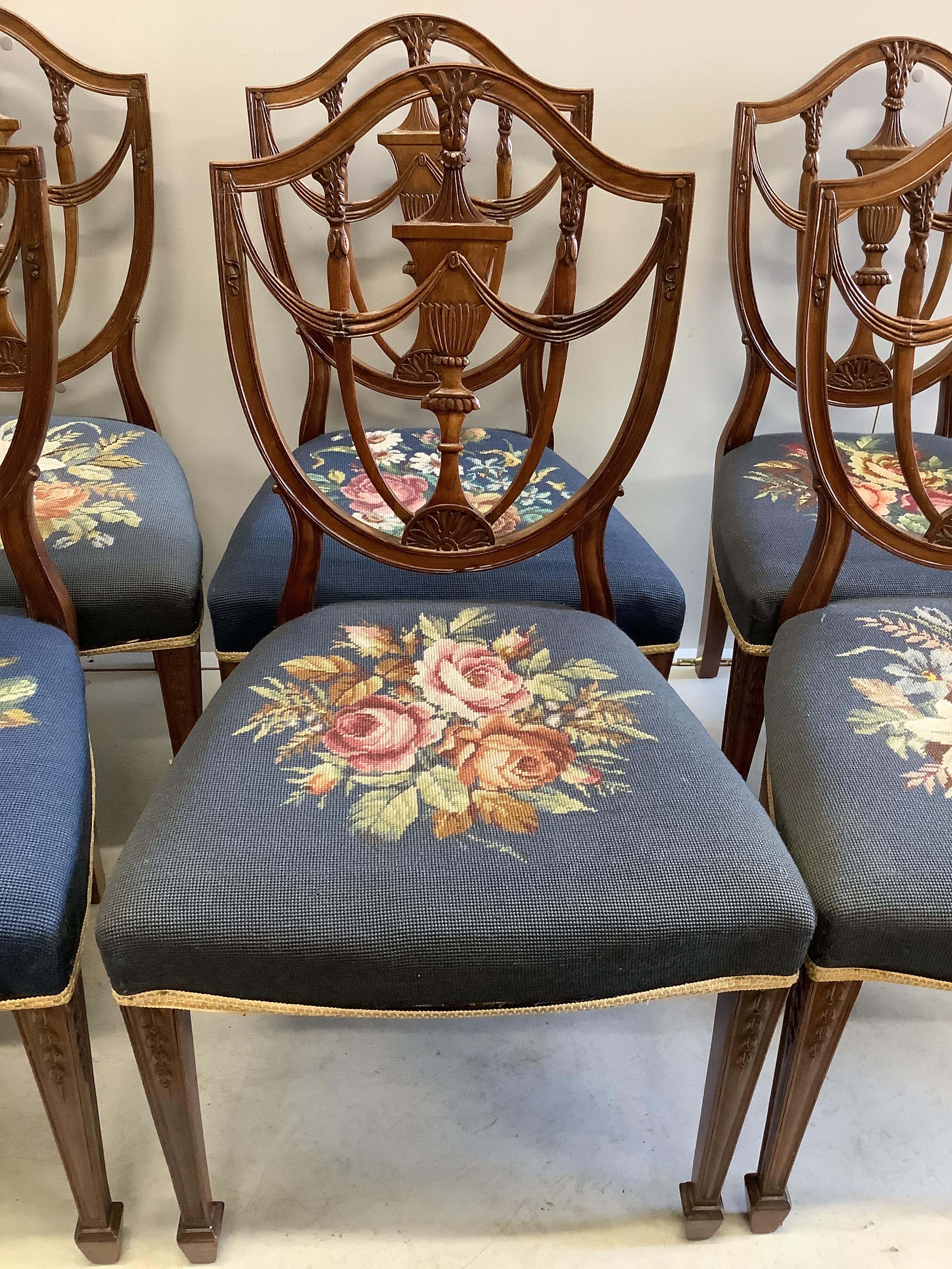 A set of eight Edwardian Hepplewhite style mahogany dining chairs with tapestry seats, two with arms